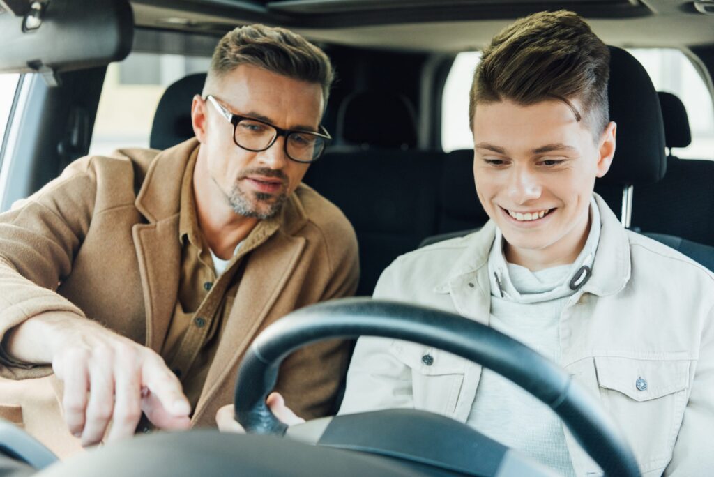 A father teaching his son to drive illustrating the need for mentoring men