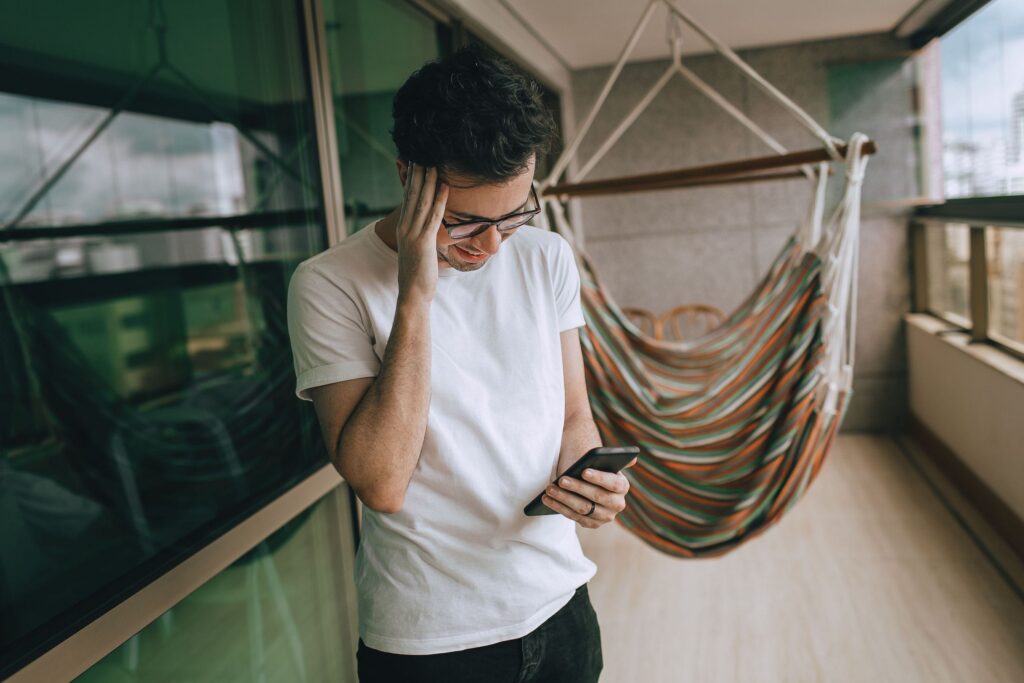 Man upset looking at his phone texting someone