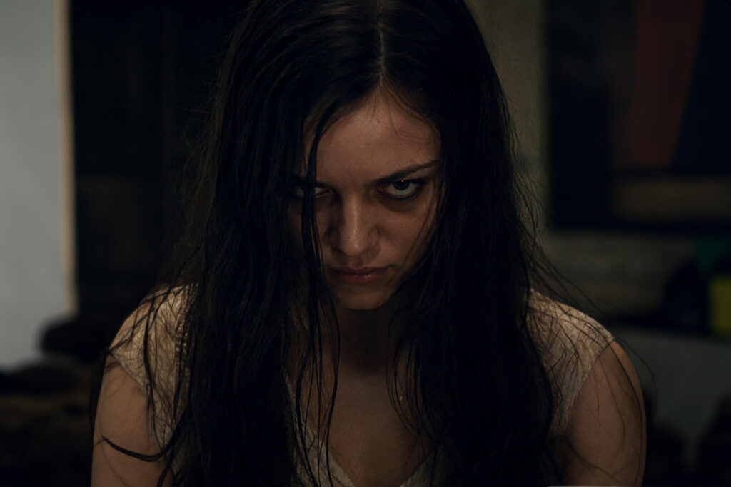 A young woman starring with a scowl